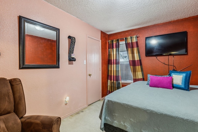 bedroom with carpet floors, a textured ceiling, and baseboards