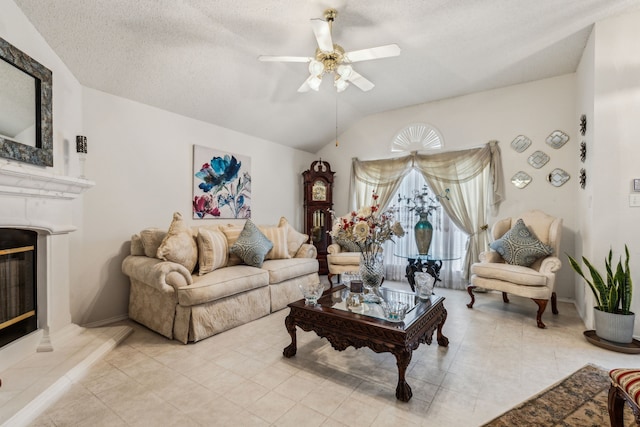 living area with a ceiling fan, a fireplace, vaulted ceiling, light tile patterned floors, and baseboards