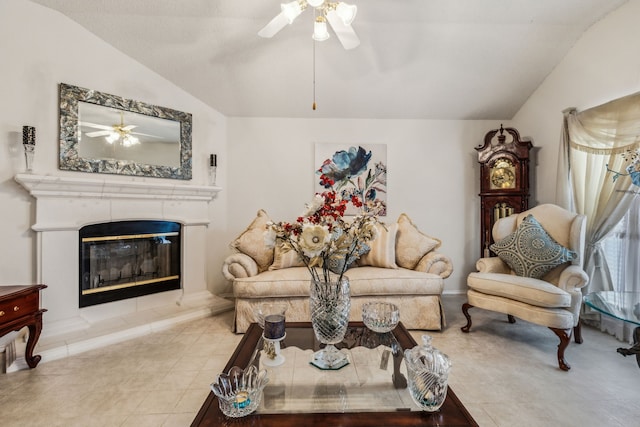 living area featuring tile patterned floors, a fireplace, a ceiling fan, and lofted ceiling
