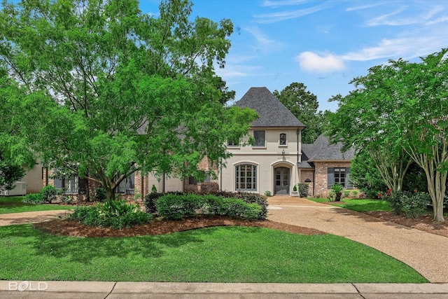 10535 Longfellow Trce, Shreveport, LA 71106 - view of front of property featuring stucco siding, a front lawn, and roof with shingles
