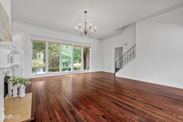 10535 Longfellow Trce, Shreveport, LA 71106 - unfurnished living room featuring stairs, a chandelier, wood-type flooring, a tiled fireplace, and crown molding