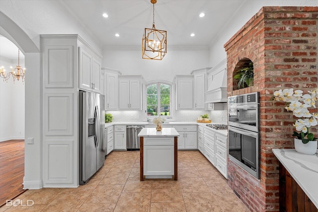 10535 Longfellow Trce, Shreveport, LA 71106 - kitchen with stainless steel appliances, a chandelier, light countertops, backsplash, and crown molding