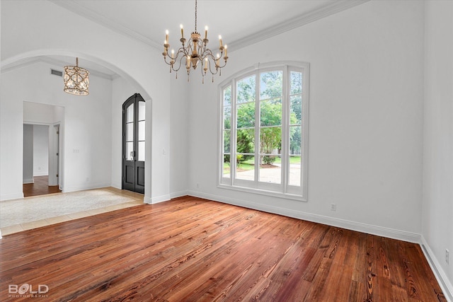 10535 Longfellow Trce, Shreveport, LA 71106 - spare room with a chandelier, arched walkways, hardwood / wood-style floors, baseboards, and crown molding