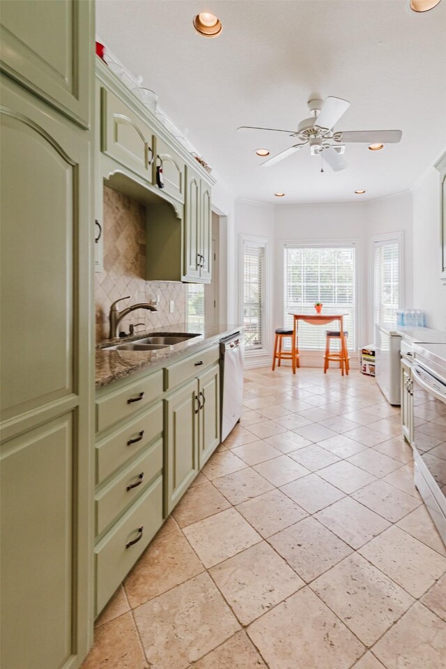 1503 S College Ave, Decatur, TX 76234 - kitchen featuring a sink, green cabinets, dishwasher, a ceiling fan, and decorative backsplash