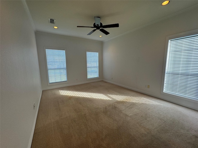 unfurnished room featuring baseboards, ornamental molding, carpet flooring, and visible vents