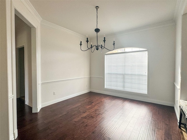 unfurnished dining area featuring an inviting chandelier, ornamental molding, and dark wood-style floors