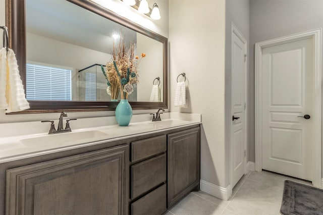 full bathroom featuring a sink, tile patterned floors, an enclosed shower, and double vanity
