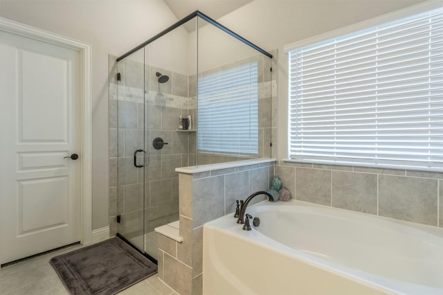 bathroom featuring a garden tub and a stall shower