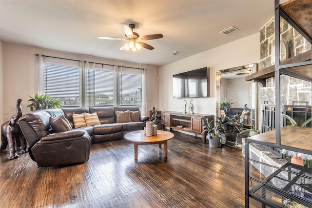 living room with ceiling fan, wood finished floors, and visible vents