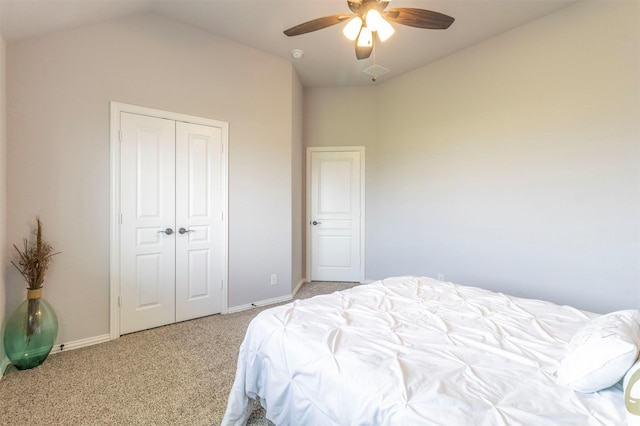 carpeted bedroom featuring baseboards, vaulted ceiling, visible vents, and a closet