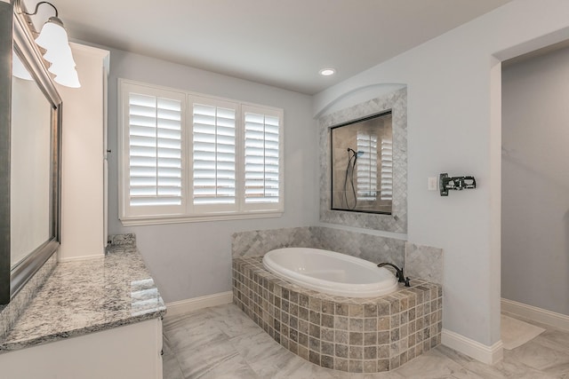 full bathroom with marble finish floor, baseboards, a garden tub, and vanity