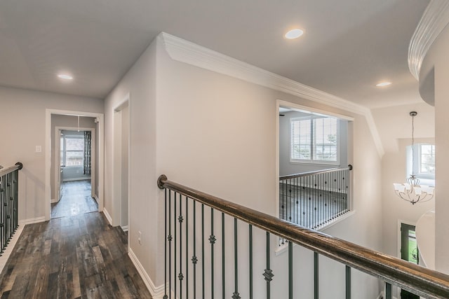corridor featuring an upstairs landing, baseboards, dark wood-style floors, a notable chandelier, and recessed lighting