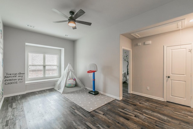 recreation room featuring attic access, a ceiling fan, baseboards, wood finished floors, and visible vents
