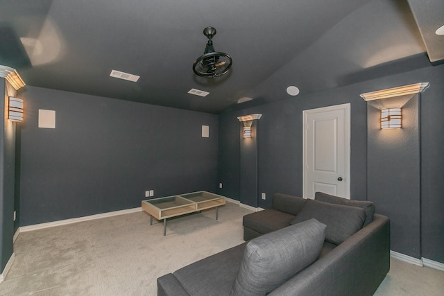carpeted cinema with visible vents, baseboards, and lofted ceiling