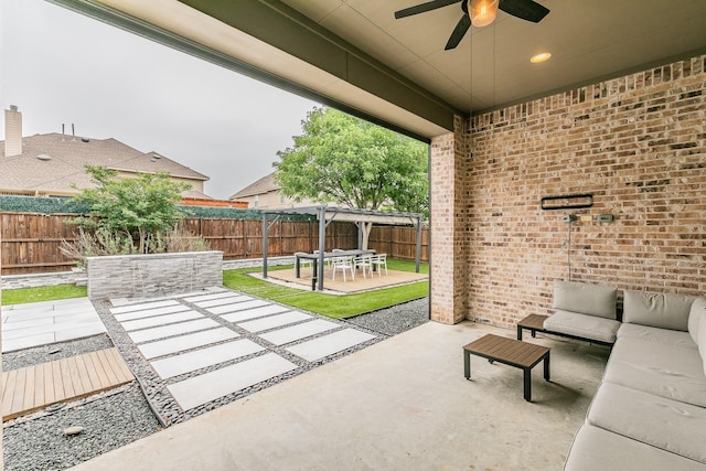 view of patio with a fenced backyard, a ceiling fan, and an outdoor hangout area