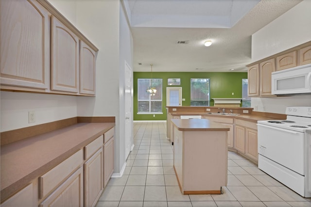 520 Jeff Grimes Blvd, Desoto, TX 75115 - kitchen with white appliances, a peninsula, light brown cabinetry, and a sink