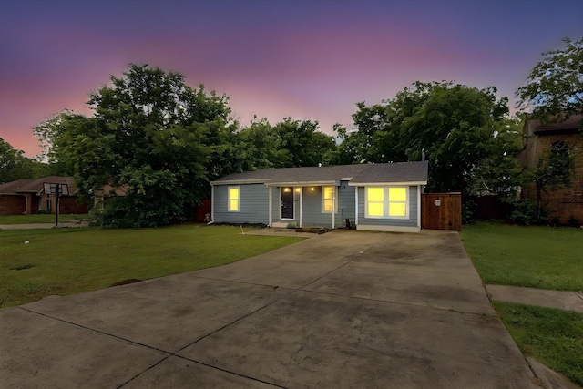 single story home with a lawn and driveway