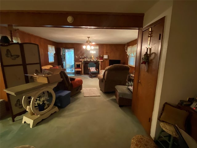 living room featuring light colored carpet, wood walls, and plenty of natural light