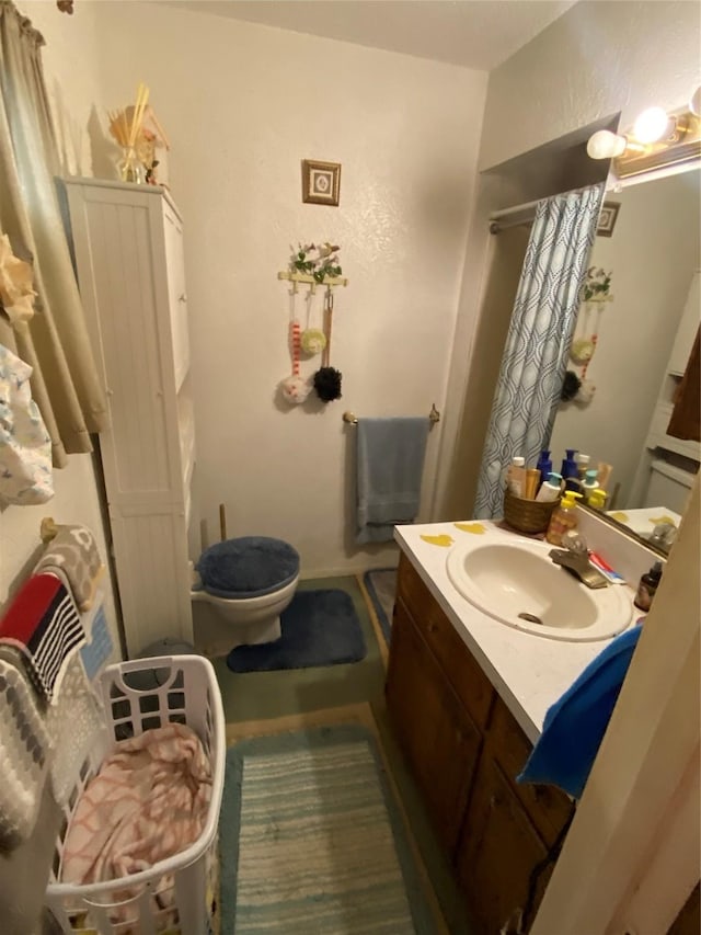 bathroom featuring vanity and toilet
