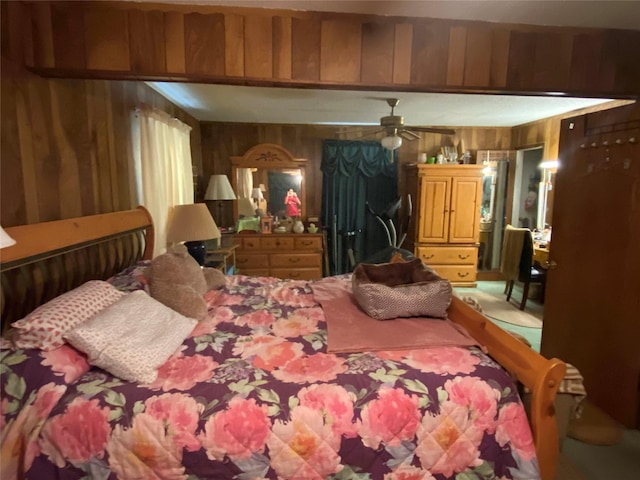 carpeted bedroom featuring wood walls