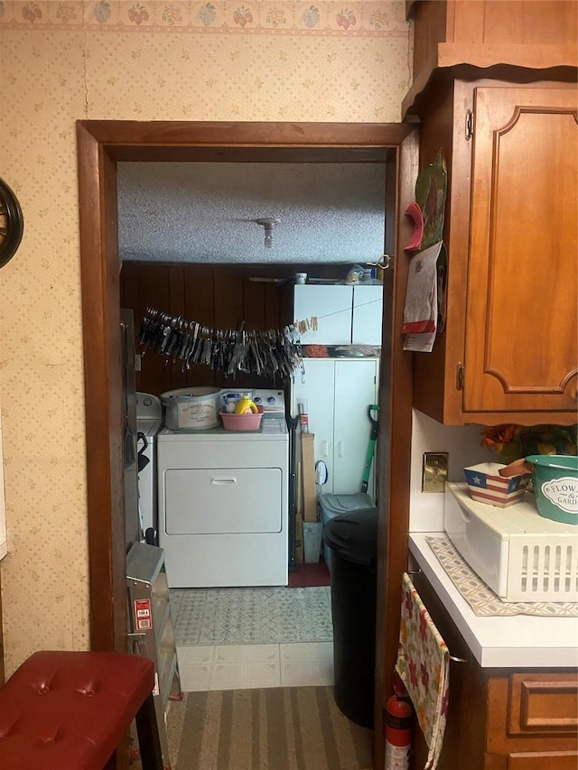 clothes washing area with wallpapered walls
