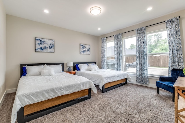 carpeted bedroom with baseboards, multiple windows, and recessed lighting