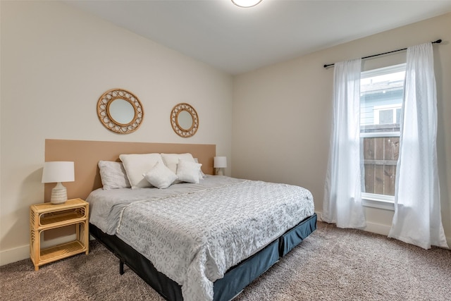 bedroom with baseboards and carpet