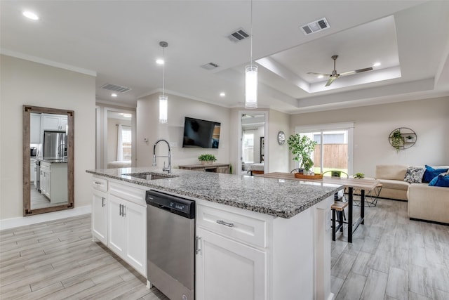kitchen with open floor plan, appliances with stainless steel finishes, a sink, and visible vents