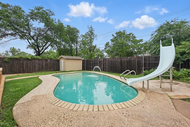 view of swimming pool featuring an outdoor structure, a patio, a fenced backyard, a fenced in pool, and a storage shed