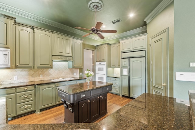 1304 Regency Ct, Southlake, TX 76092 - kitchen with light wood finished floors, a ceiling fan, ornamental molding, white appliances, and tasteful backsplash