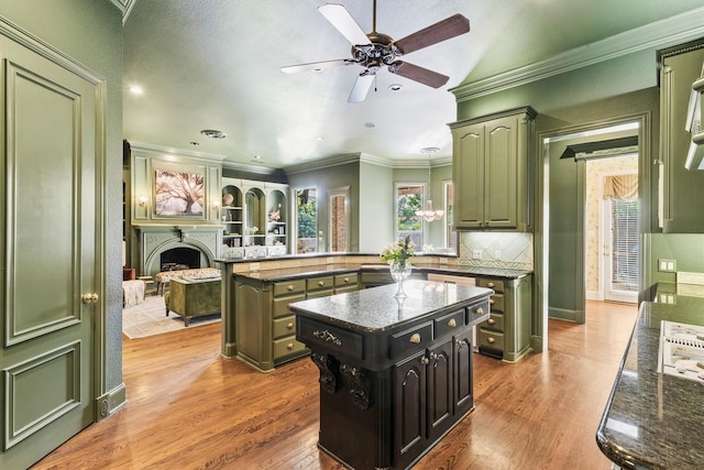1304 Regency Ct, Southlake, TX 76092 - kitchen with green cabinets, wood finished floors, a peninsula, crown molding, and a ceiling fan