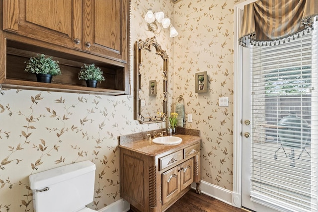 1304 Regency Ct, Southlake, TX 76092 - bathroom with wallpapered walls, vanity, wood finished floors, toilet, and baseboards