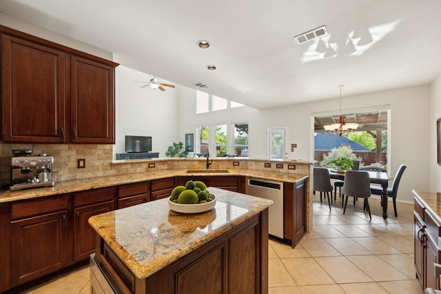 kitchen featuring a sink, visible vents, dishwasher, decorative backsplash, and light tile patterned flooring