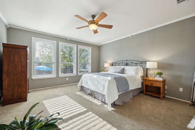 bedroom featuring visible vents, crown molding, ceiling fan, carpet flooring, and baseboards