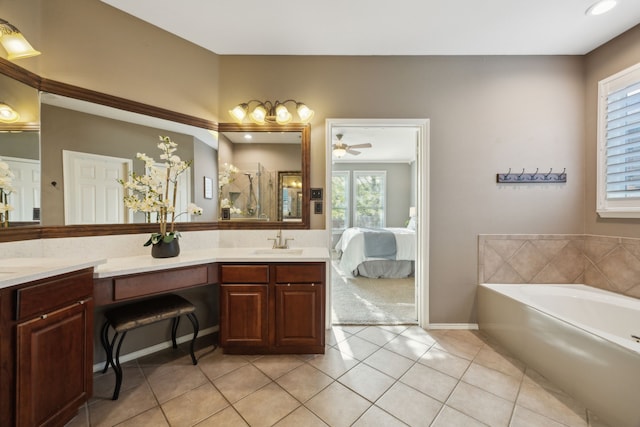 full bathroom with vanity, a garden tub, a ceiling fan, and tile patterned floors