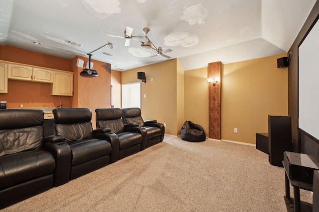 home theater with ceiling fan, carpet flooring, visible vents, and vaulted ceiling