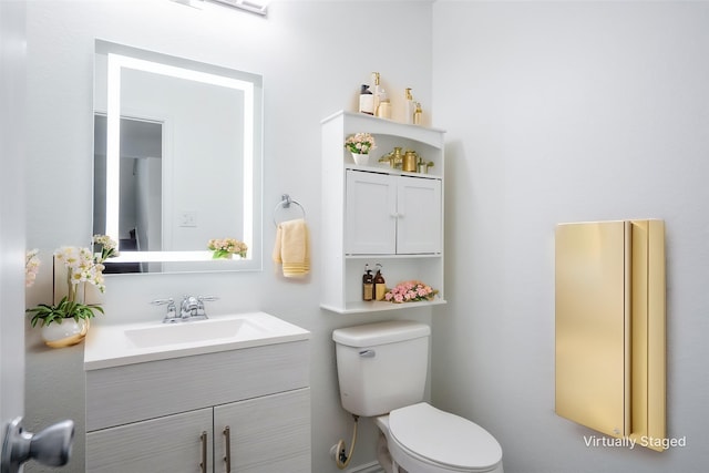 half bathroom with toilet and vanity