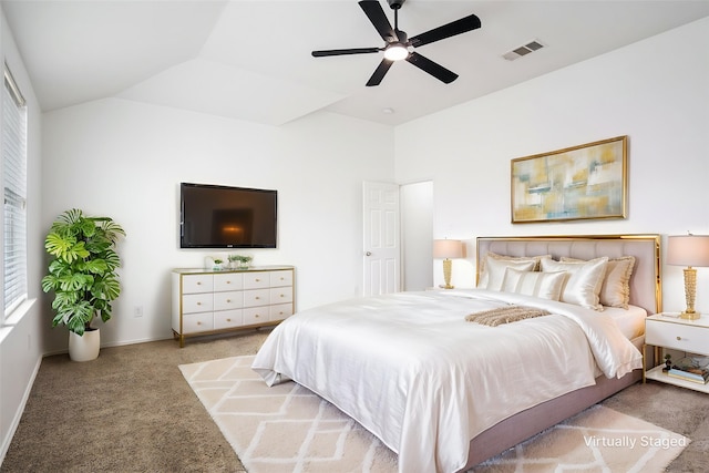 carpeted bedroom with baseboards, a ceiling fan, vaulted ceiling, and visible vents