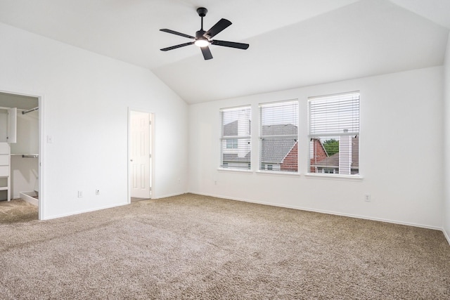 unfurnished room with carpet floors, ceiling fan, baseboards, and lofted ceiling