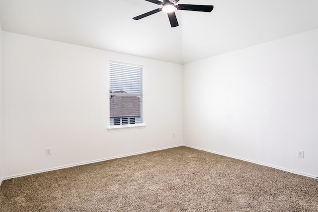 spare room with carpet flooring, a ceiling fan, baseboards, and vaulted ceiling