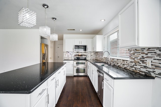 kitchen featuring a sink, stainless steel appliances, recessed lighting, decorative backsplash, and visible vents