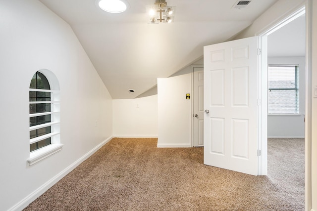additional living space with baseboards, carpet flooring, and lofted ceiling