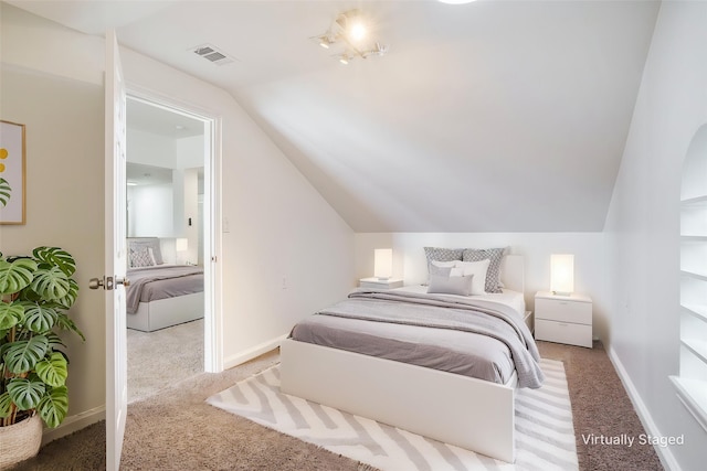 bedroom featuring baseboards, carpet, vaulted ceiling, and visible vents