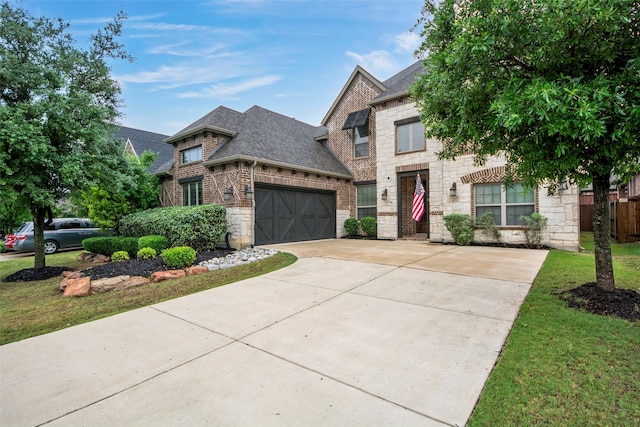 2026 Grassland Dr, Allen, TX 75013 - french country inspired facade featuring concrete driveway, a shingled roof, stone siding, and a garage