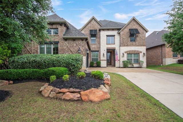 2026 Grassland Dr, Allen, TX 75013 - french country style house with brick siding, a front yard, and stone siding