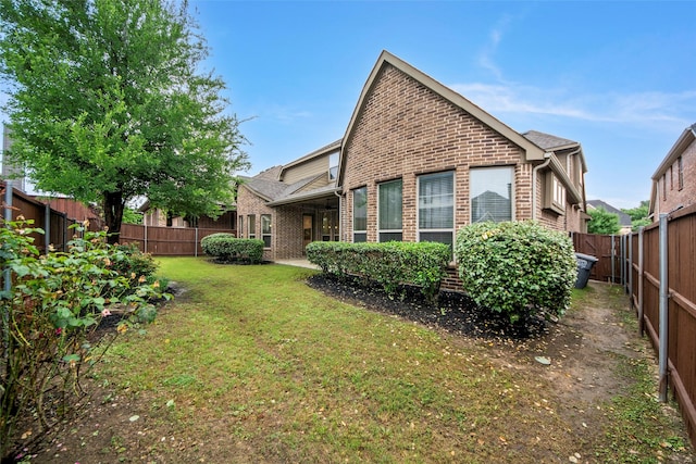 2026 Grassland Dr, Allen, TX 75013 - back of property with brick siding, a fenced backyard, and a lawn