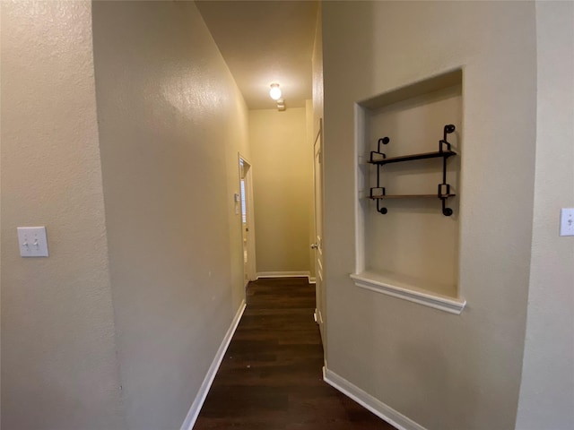 hall with baseboards and dark wood finished floors