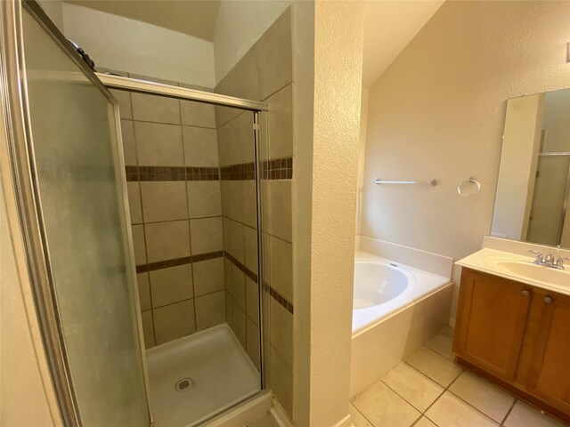 full bath featuring a garden tub, vanity, tile patterned flooring, and a shower stall