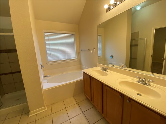 bathroom featuring tile patterned floors, a sink, a garden tub, and a stall shower
