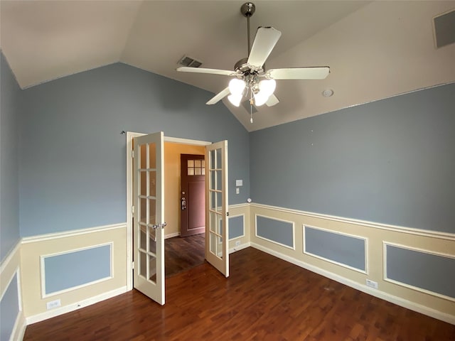 spare room with visible vents, wainscoting, wood finished floors, french doors, and vaulted ceiling
